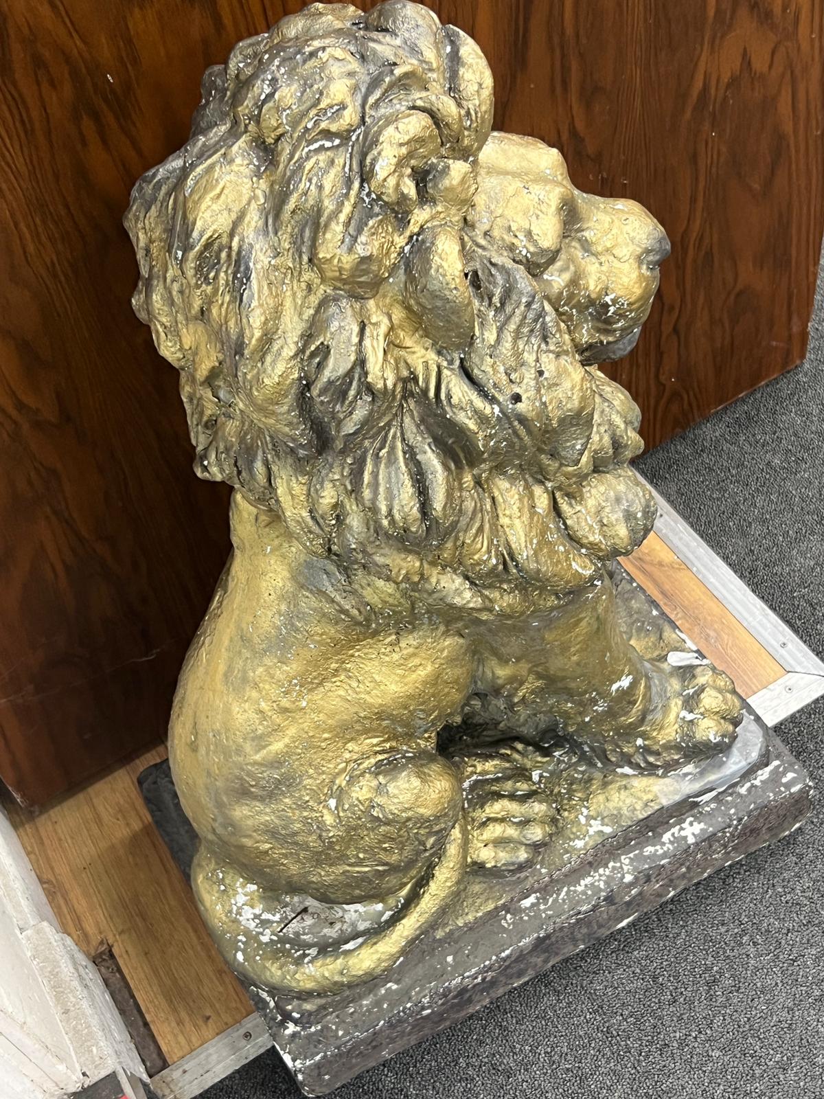 A painted composition faux stone lion garden ornament, height 65cm